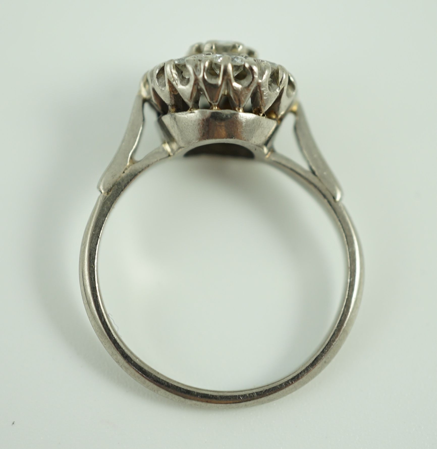 An 18ct white gold and nine stone diamond flower head cluster ring